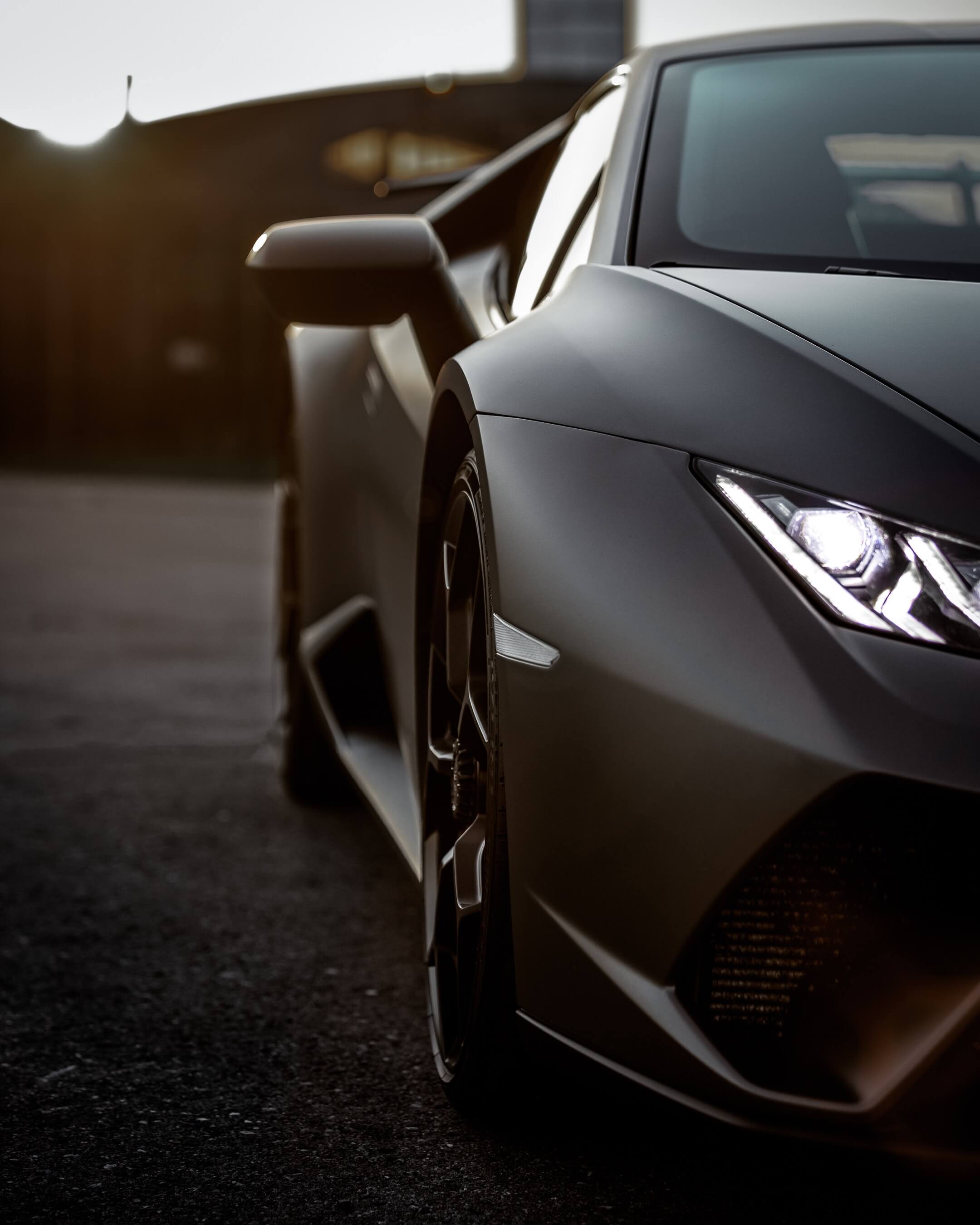 Close-up, front-side view of sporty car's headlights.