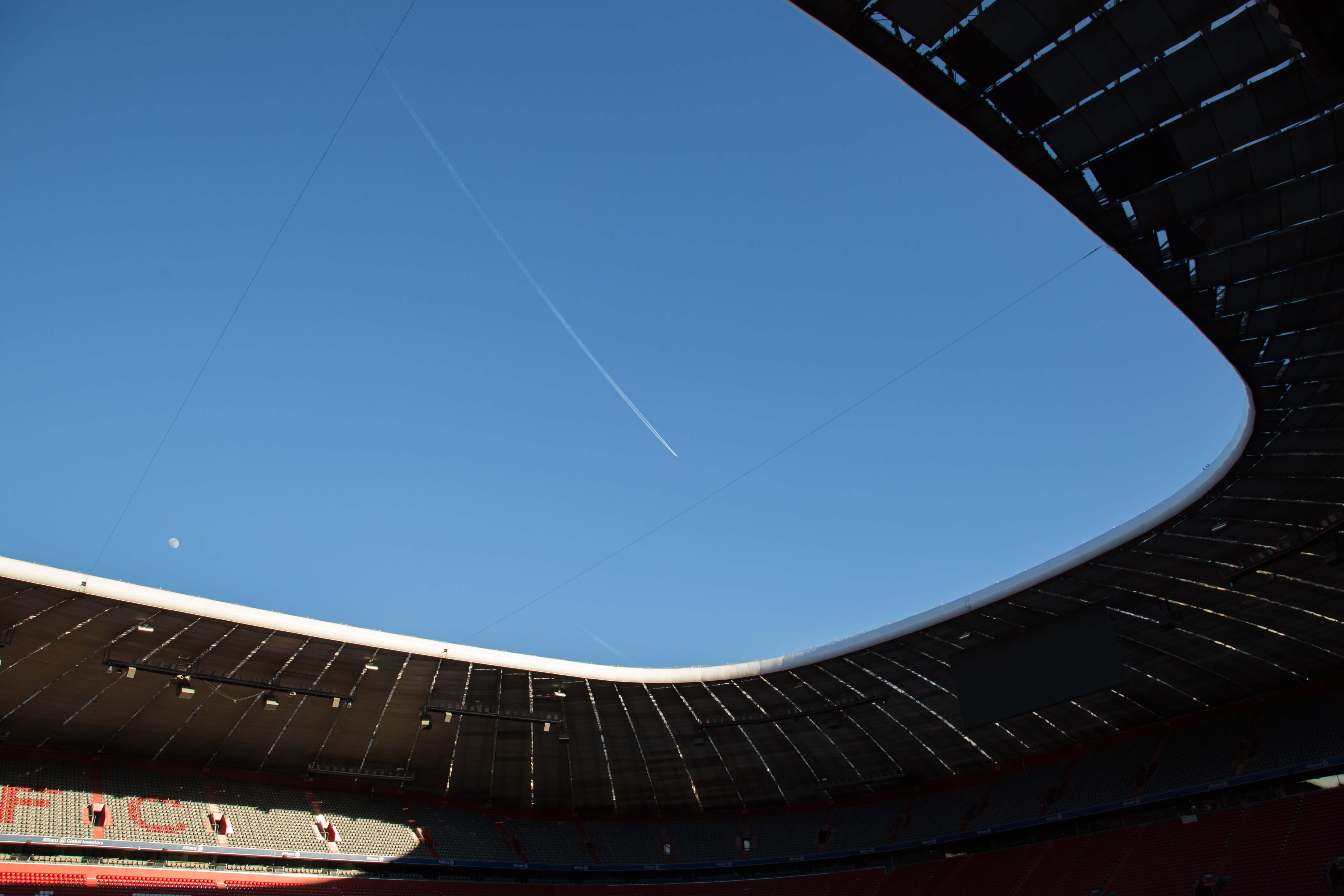 View of blue sky from the inside of a sports stadium.